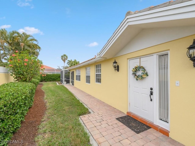 property entrance with a yard