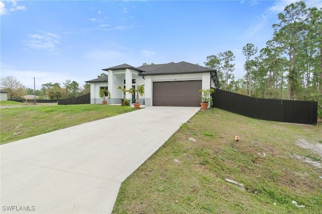 view of front facade with a garage and a front yard