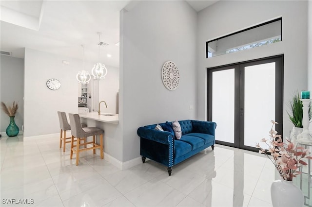1114 Clayton Ave, Lehigh Acres, FL 33972 - entryway with sink, a towering ceiling, and french doors