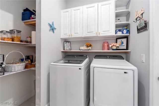 washroom featuring cabinets and washer and dryer