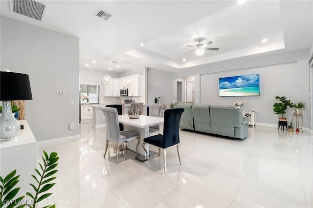 1114 Clayton Ave, Lehigh Acres, FL 33972 - dining area with a tray ceiling and ceiling fan