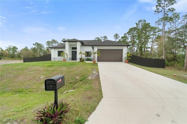 view of front of house featuring a garage and a front yard