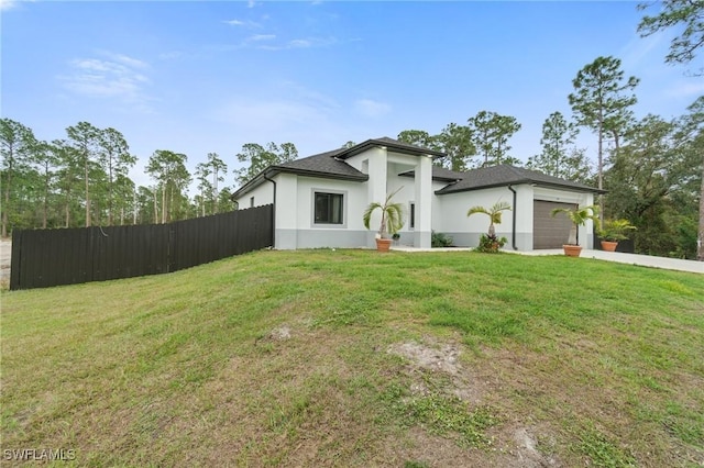 1114 Clayton Ave, Lehigh Acres, FL 33972 - view of front of house featuring a garage and a front lawn