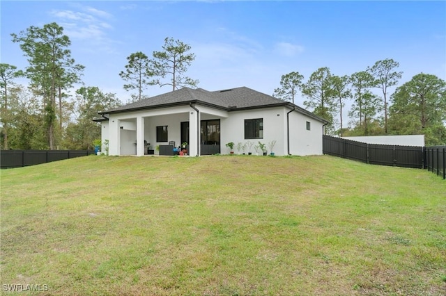 back of house featuring a yard