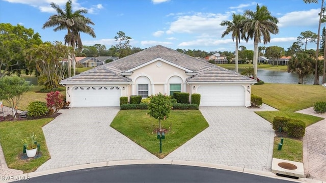 single story home featuring a front yard, a garage, and a water view