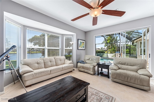 living room with plenty of natural light, ceiling fan, and light tile patterned flooring