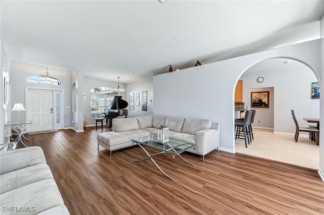 living room with wood-type flooring and a chandelier