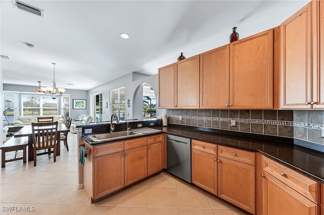 kitchen with sink, light tile patterned floors, dishwasher, hanging light fixtures, and decorative backsplash