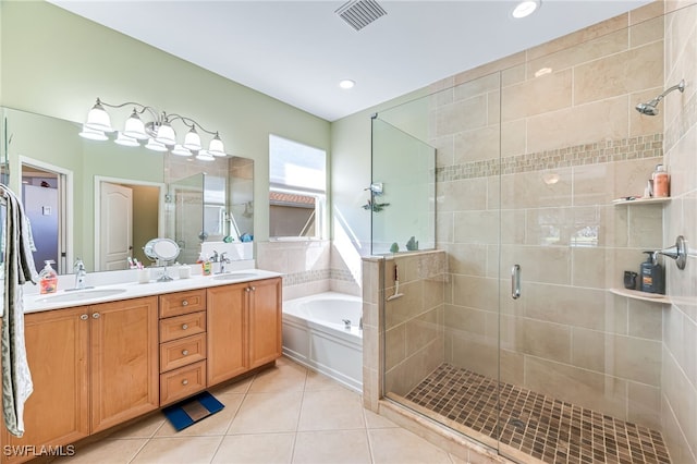 bathroom featuring independent shower and bath, vanity, and tile patterned floors