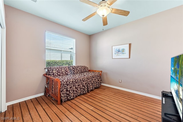 sitting room featuring ceiling fan and hardwood / wood-style floors