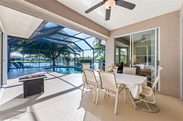 view of pool featuring ceiling fan, an outdoor fire pit, a lanai, and a patio