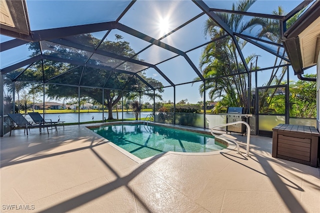 view of pool with a water view, a patio, and glass enclosure