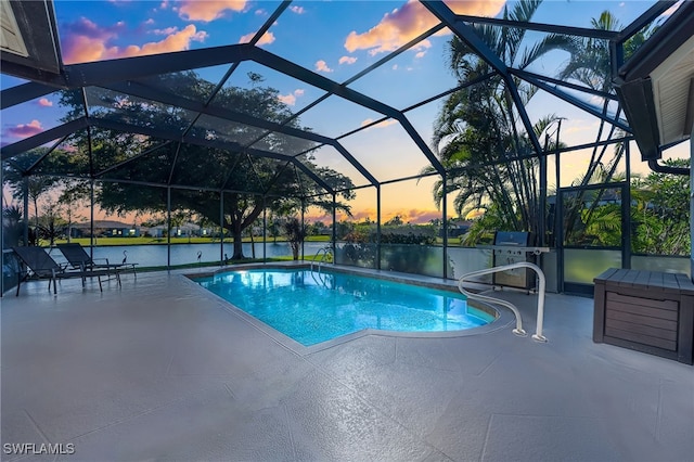 pool at dusk with a water view, a lanai, and a patio