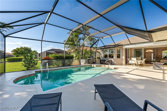 view of pool featuring a patio and glass enclosure