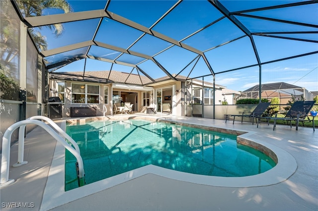 view of pool with a patio and a lanai