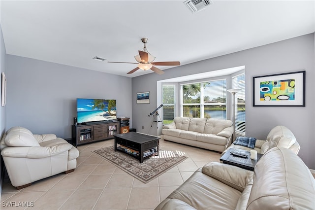 living room featuring light tile patterned flooring and ceiling fan