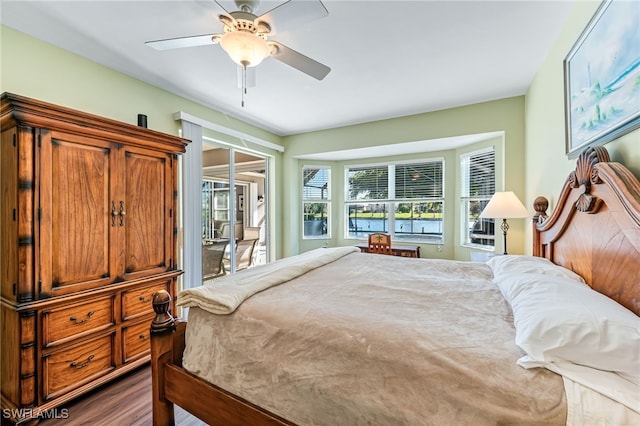 bedroom with dark hardwood / wood-style flooring, access to exterior, and ceiling fan