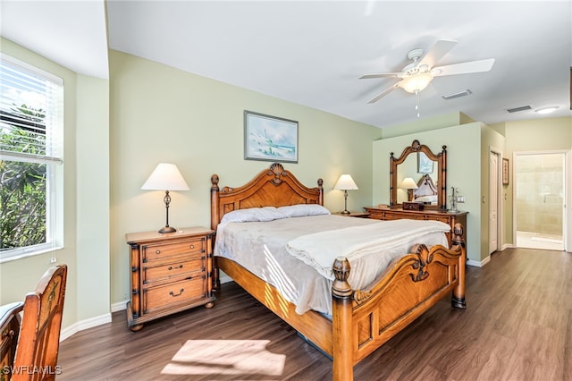 bedroom featuring dark hardwood / wood-style floors, ceiling fan, and ensuite bathroom