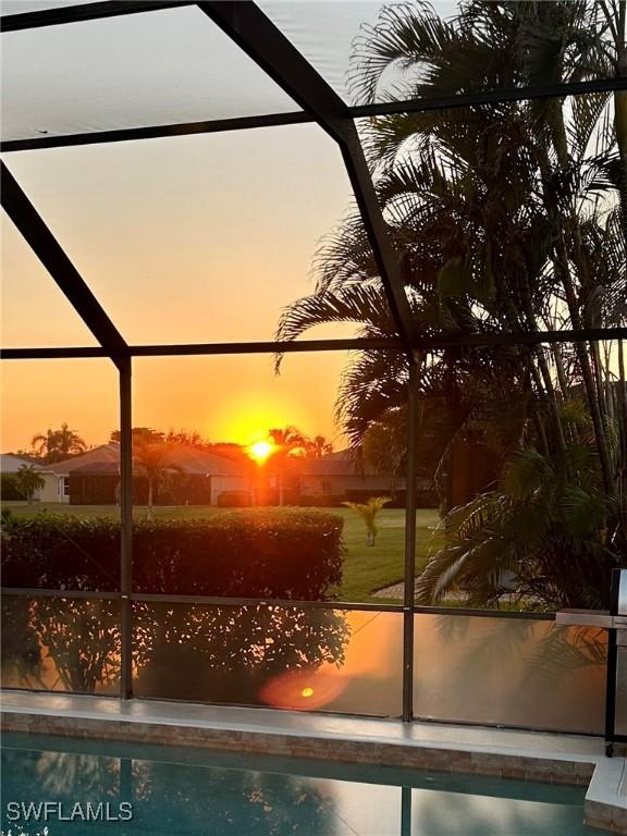 pool at dusk with glass enclosure