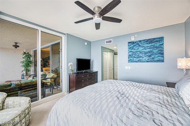 carpeted bedroom with ceiling fan and two closets