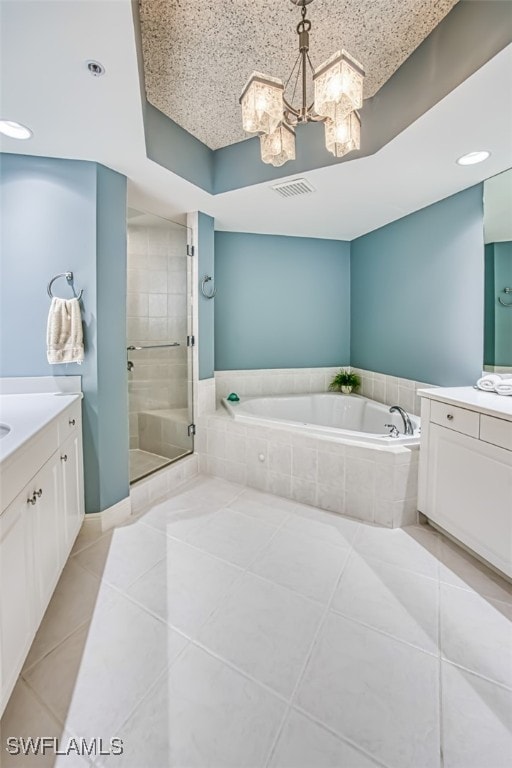 bathroom with tile patterned floors, vanity, separate shower and tub, and an inviting chandelier