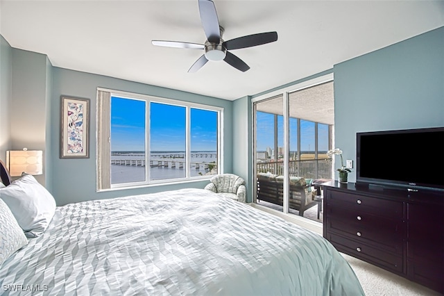 carpeted bedroom with ceiling fan and access to outside