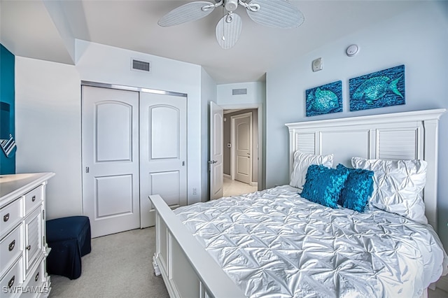 bedroom featuring ceiling fan, light colored carpet, and a closet