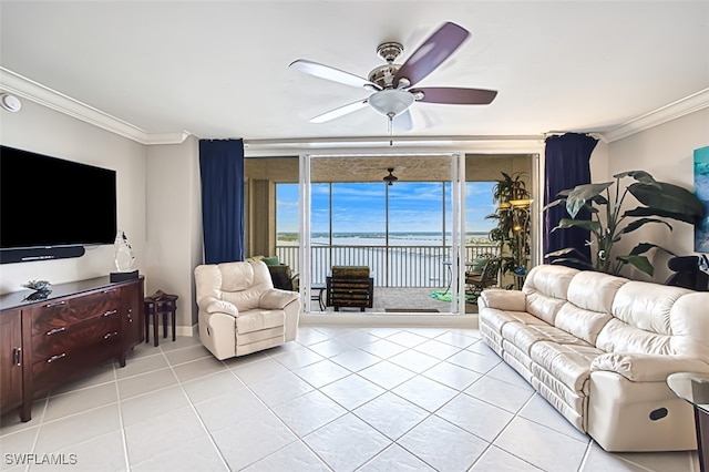 tiled living room featuring ceiling fan, ornamental molding, a water view, and floor to ceiling windows