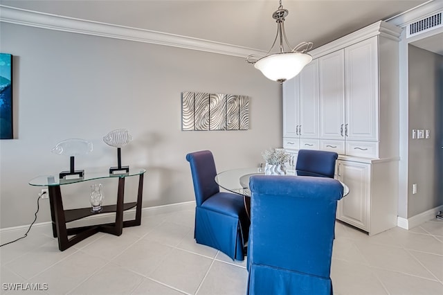 dining space featuring light tile patterned floors and crown molding