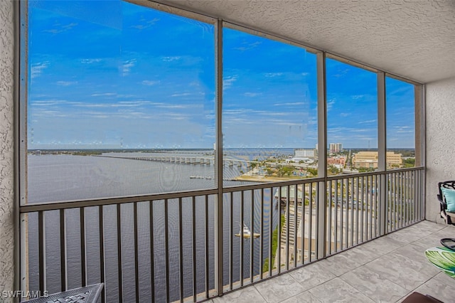 unfurnished sunroom featuring a water view