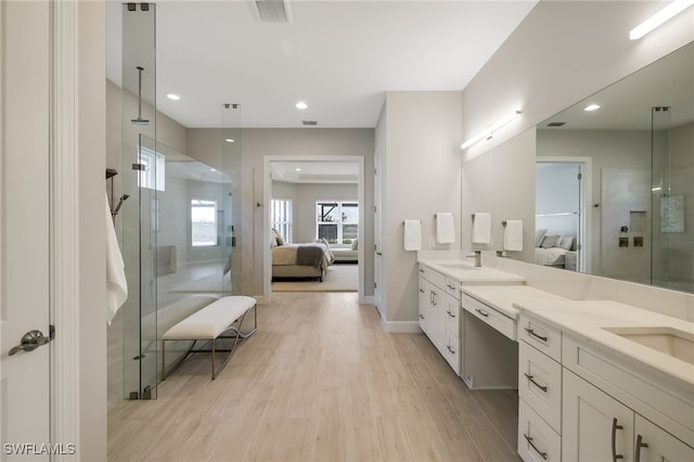 bathroom featuring a shower with shower door, wood-type flooring, and vanity