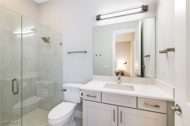 bathroom with toilet, vanity, and walk in shower