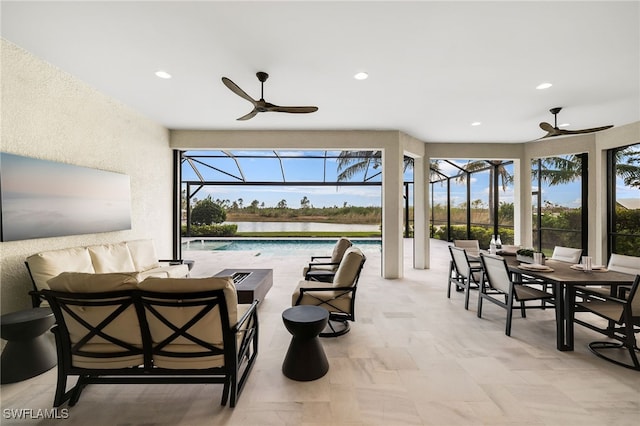 view of patio with ceiling fan, glass enclosure, a water view, and outdoor lounge area