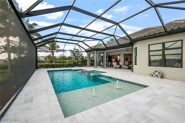 view of pool with a lanai, pool water feature, and a patio