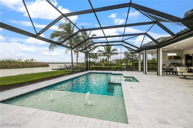 view of swimming pool with pool water feature, grilling area, a patio, and glass enclosure