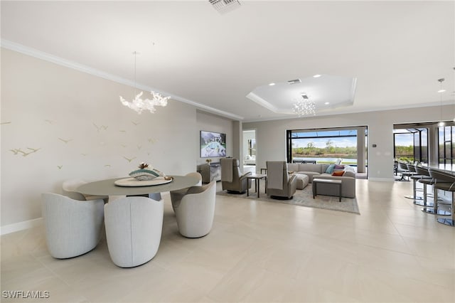 dining space featuring crown molding, a raised ceiling, and a notable chandelier