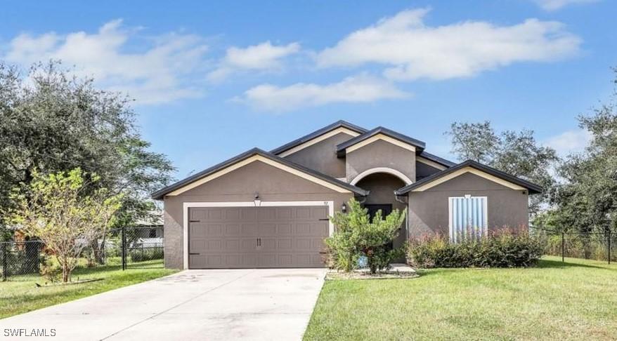 single story home with a front lawn and a garage