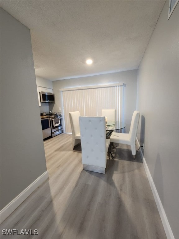 dining area with light wood-type flooring