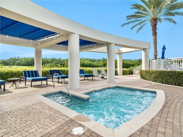 view of swimming pool featuring a patio area and a hot tub