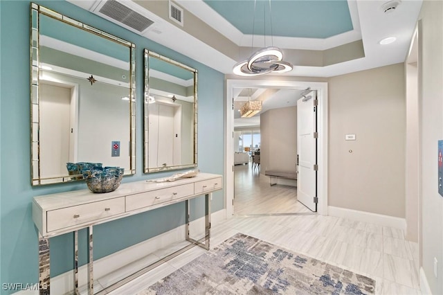 bathroom with vanity and a tray ceiling