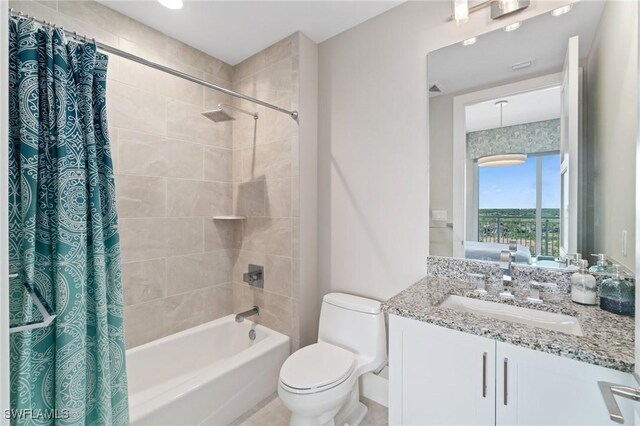 full bathroom with vanity, shower / tub combo with curtain, and toilet