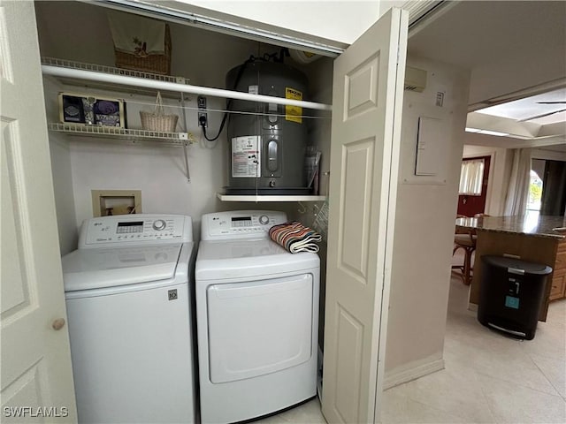 washroom featuring light tile patterned flooring and washing machine and dryer