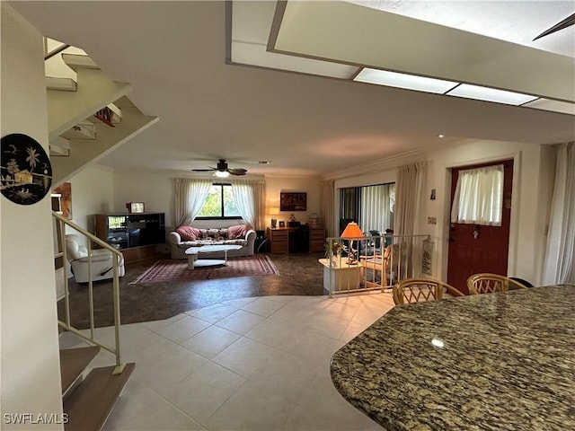 tiled dining space featuring ceiling fan