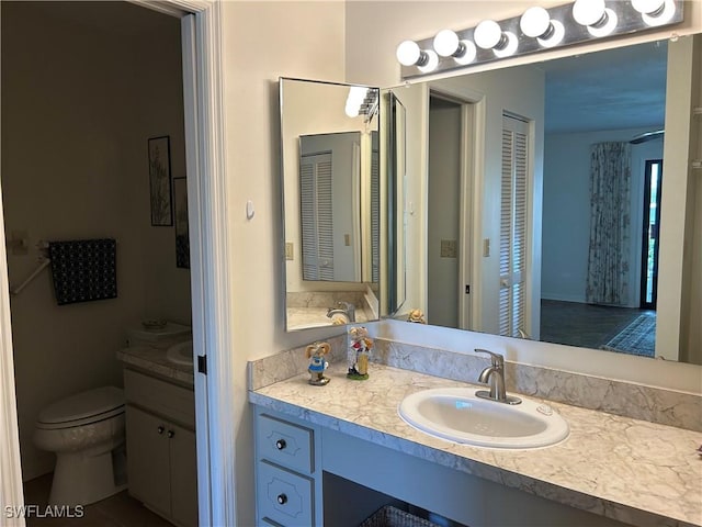 bathroom with vanity and toilet