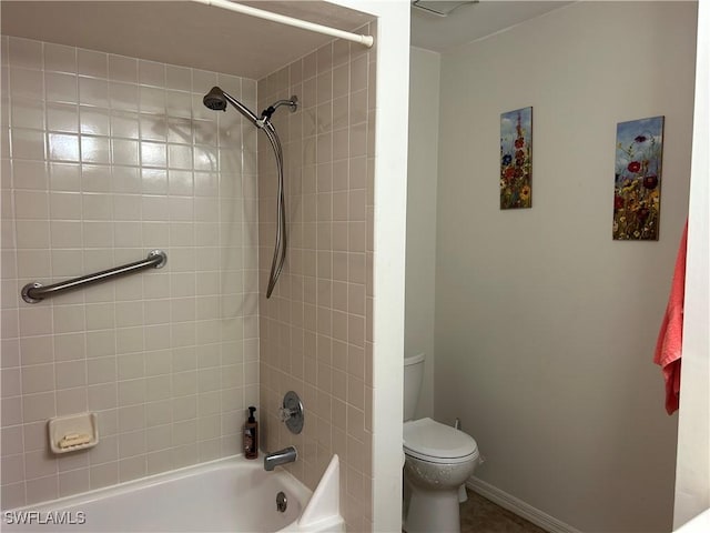 bathroom featuring toilet and tiled shower / bath combo