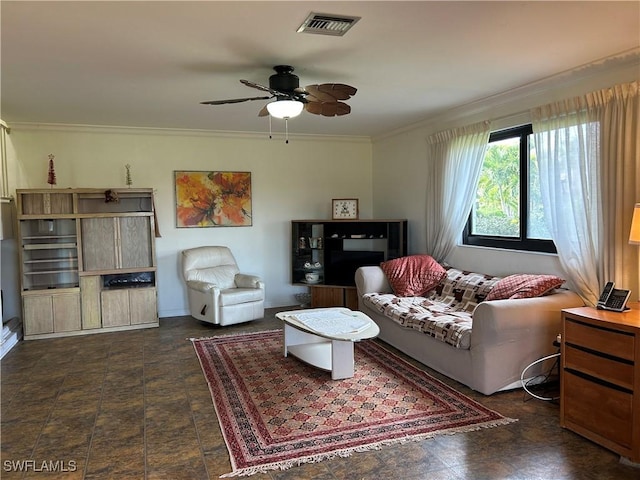 living room with ornamental molding and ceiling fan