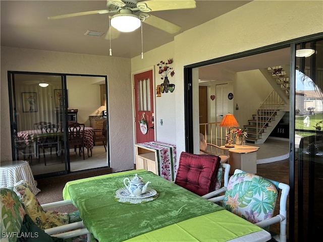 carpeted dining space featuring ceiling fan