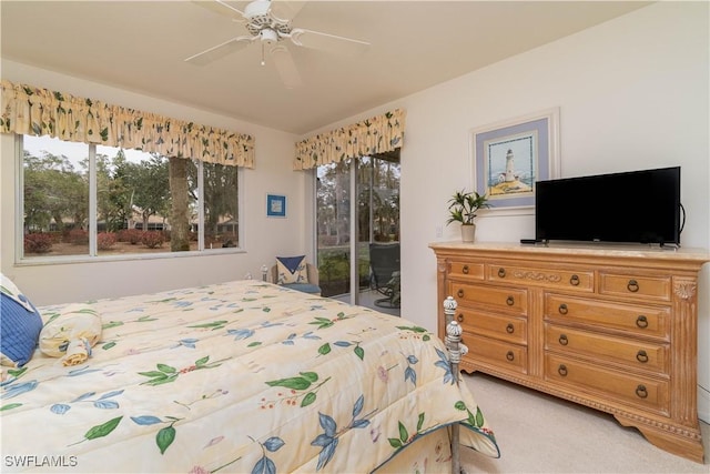 carpeted bedroom with ceiling fan and access to outside