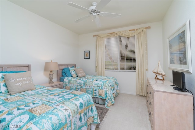 bedroom with ceiling fan and light carpet