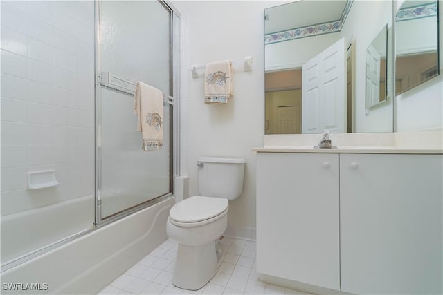 full bathroom featuring combined bath / shower with glass door, toilet, tile patterned floors, and vanity